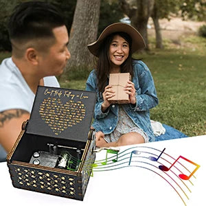 A young woman smiles while holding an antique wood music box with engraved melody.