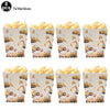A set of 8 paper cups filled with popcorn and construction vehicle themed decorations for a birthday party.