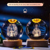 A dark crystal ball night light featuring a depiction of two figures surrounded by soft warm romantic lights.