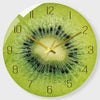A round clock face featuring a kiwi fruit design with green and yellow tones.