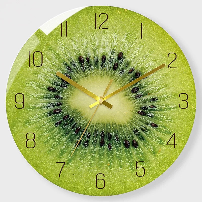 A round clock face featuring a kiwi fruit design with green and yellow tones.