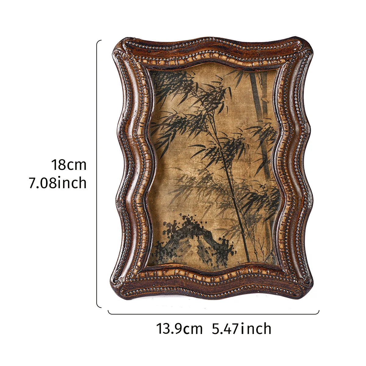A vintage resin photo frame with an ornate brown wooden border and a sepia-toned botanical print.