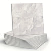 A stack of white marble peel-and-stick wall panels showing natural veining.