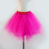A bright pink tulle tutu skirt displayed on a mannequin.