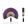 Handwoven bamboo wall fan decor featuring purple and beige stripes with a tassel.