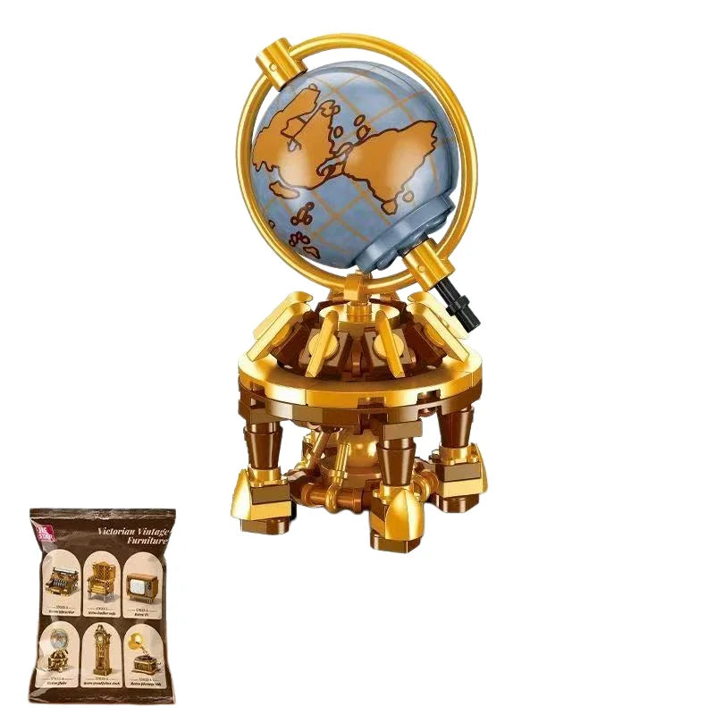 A brass globe model of North America with a golden stand and a box of miniature furniture and appliance models