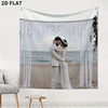 A white fabric banner featuring a photo of a couple embracing, decorated with sheer white fringe and draped fabric.