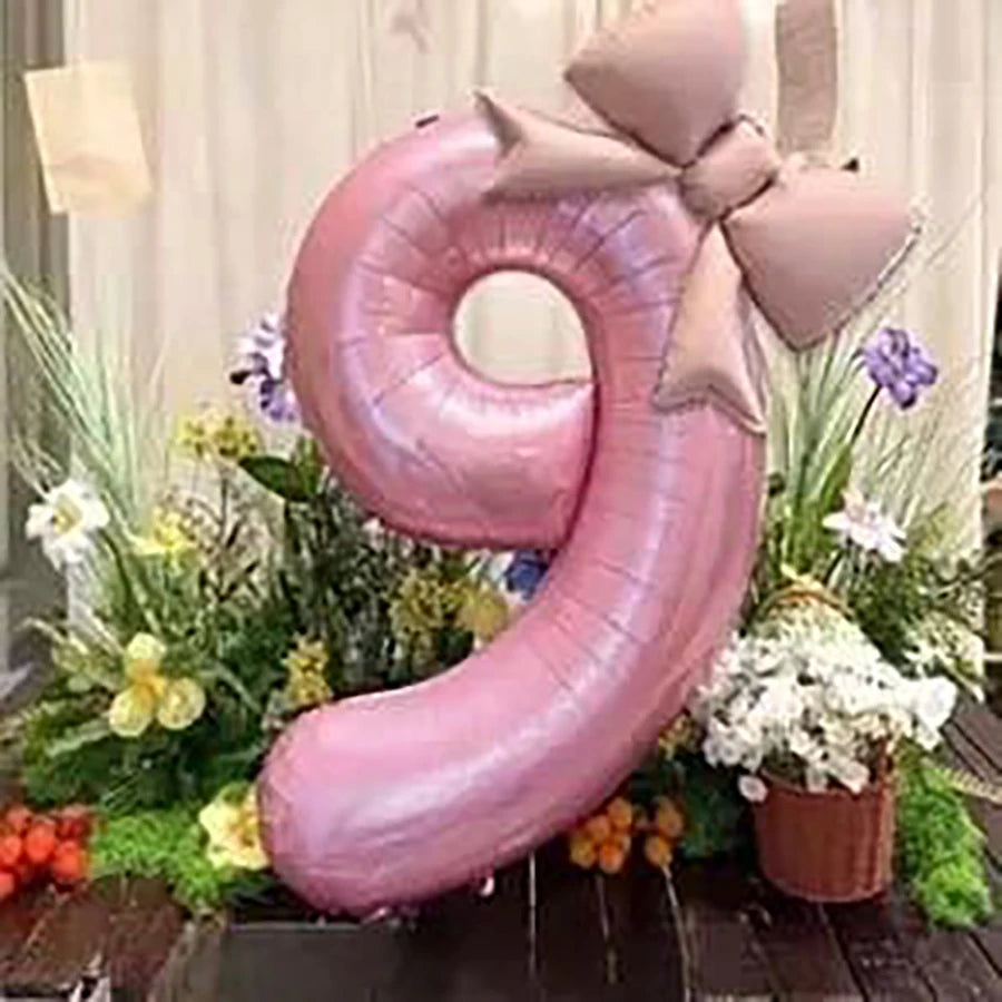 Pink 32-inch number balloon shaped like a 9 with a matte bow decoration