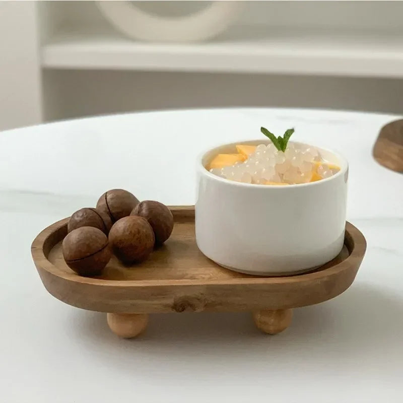 A white ceramic bowl filled with light yellow crystals sits on a wooden tray on a white surface.