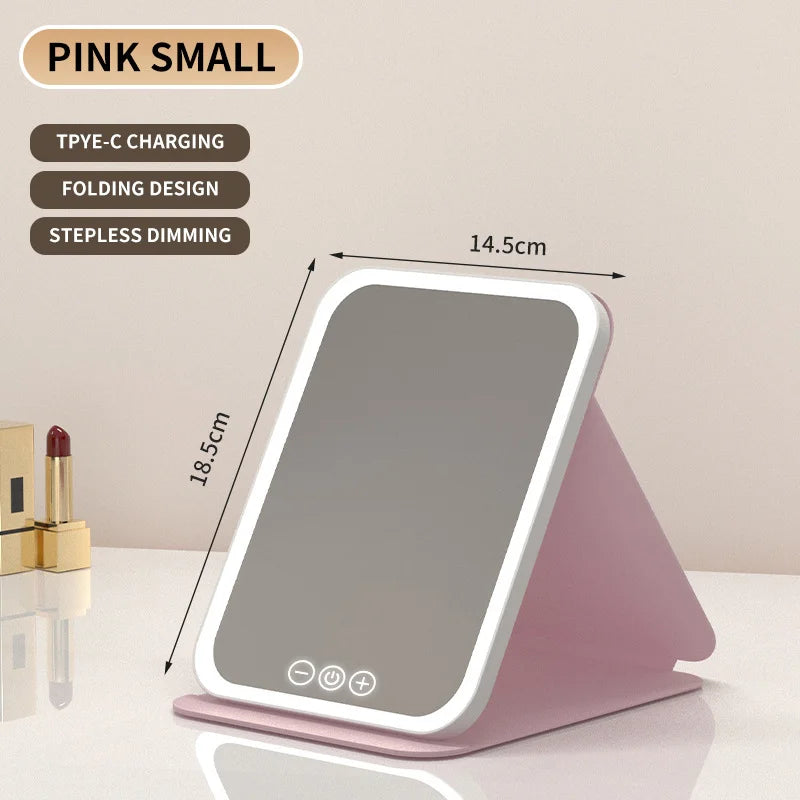 Miroir de maquillage LED rose pliable avec surface lisse et commandes tactiles.
