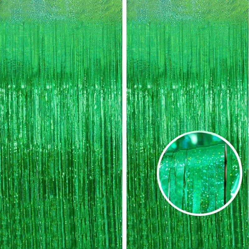 A close-up of a metallic foil tinsel fringe backdrop set in vibrant green.