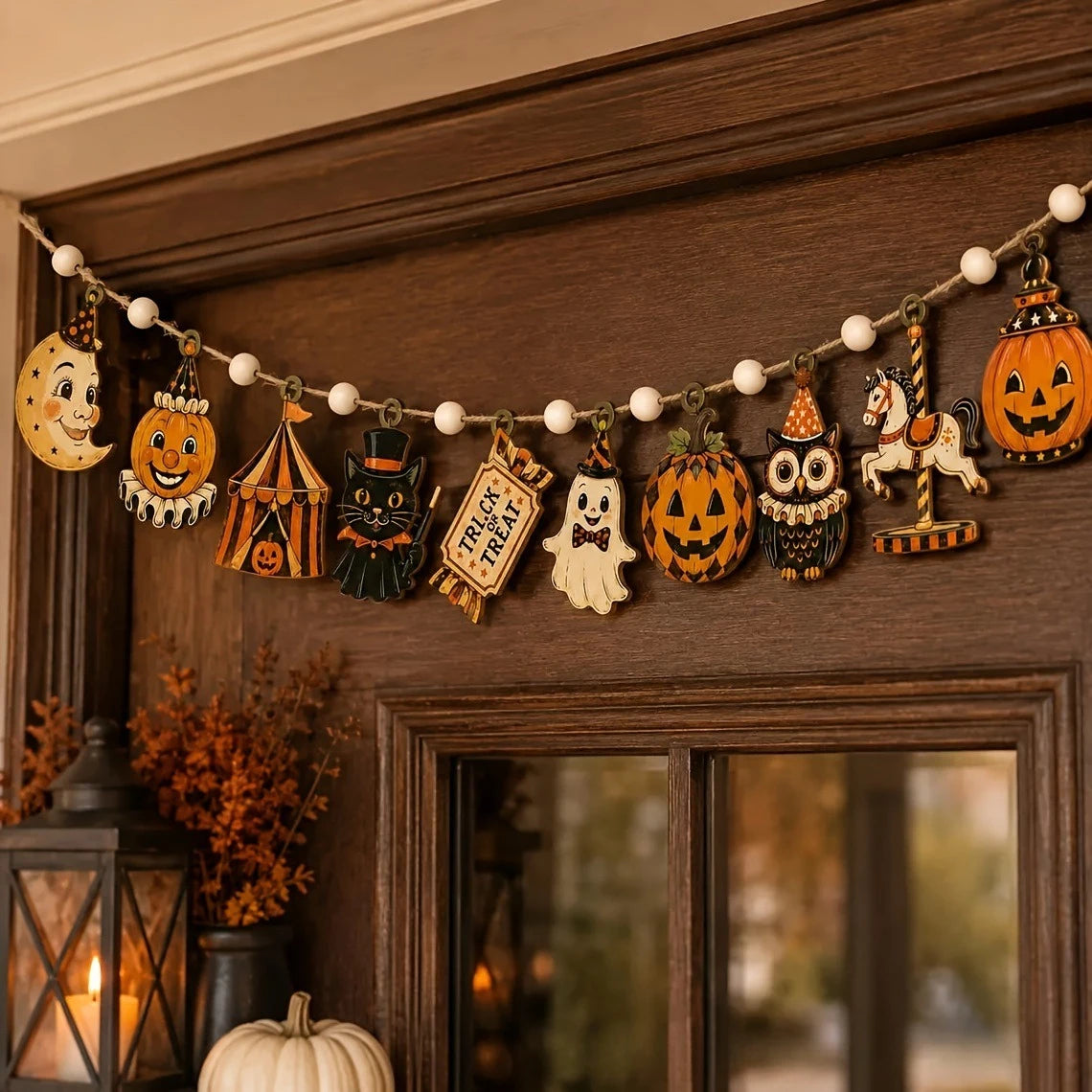 Vintage Halloween wooden hanging garland featuring retro pumpkin, ghost, and cat beads displayed on a dark brown wall.