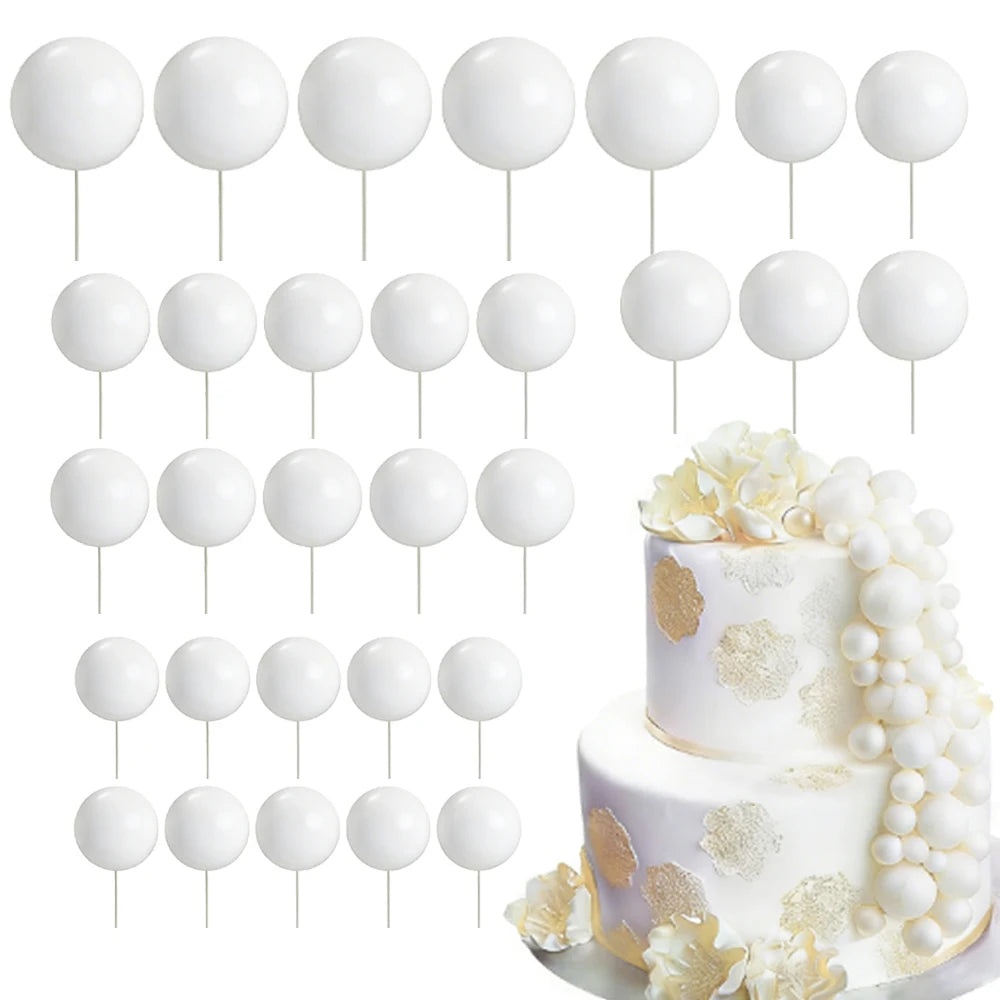 A set of white foam cake toppers on sticks, including various shapes and floral designs.