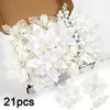 A box containing 21 stems of artificial white flowers and berries used for floral arrangements.