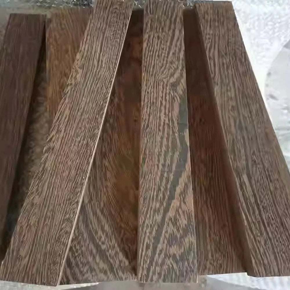 A collection of natural wood blanks for knife handles and DIY projects, showing various grain patterns.