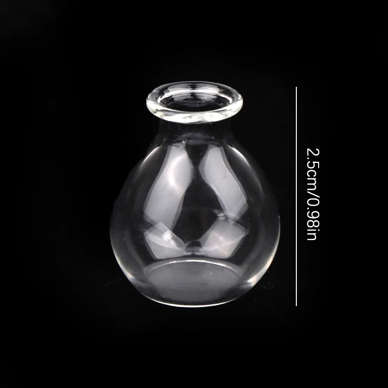 A clear glass vase with a narrow opening and a round base, shown against a black background.