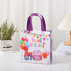 A purple non-woven gift tote bag featuring a colorful birthday theme with festive decorations.
