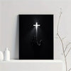 Black canvas wall art featuring a glowing cross illuminating a hand print.