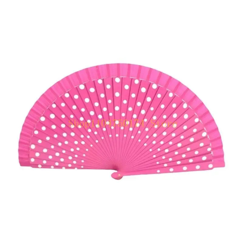 A bright pink hand fan with a pleated design and white polka dots.