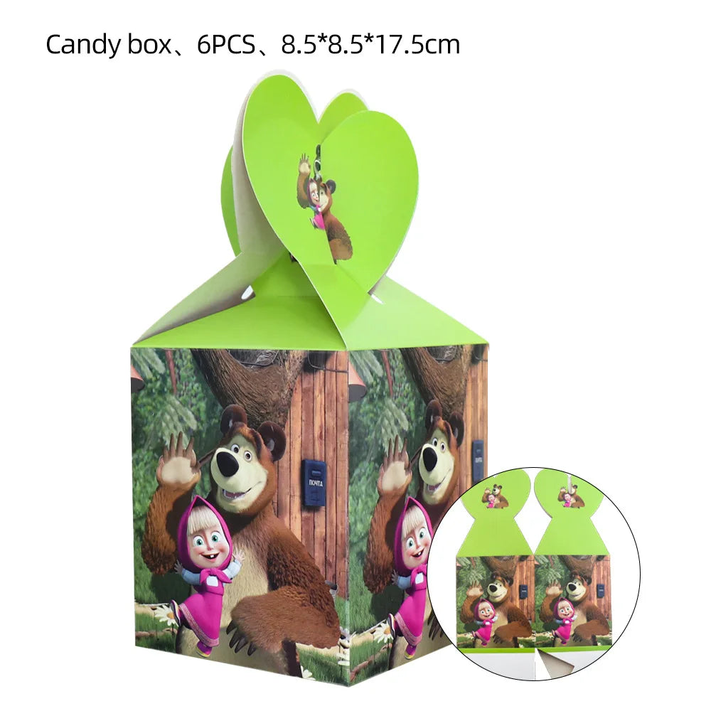 A green cardboard candy box shaped like a heart with a bear face cutout, used for birthday party supplies.