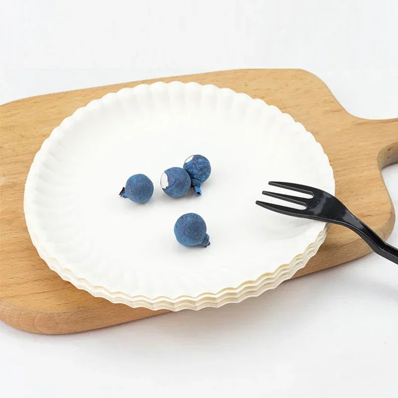 Three dark blue paper plates resting on a wooden board.