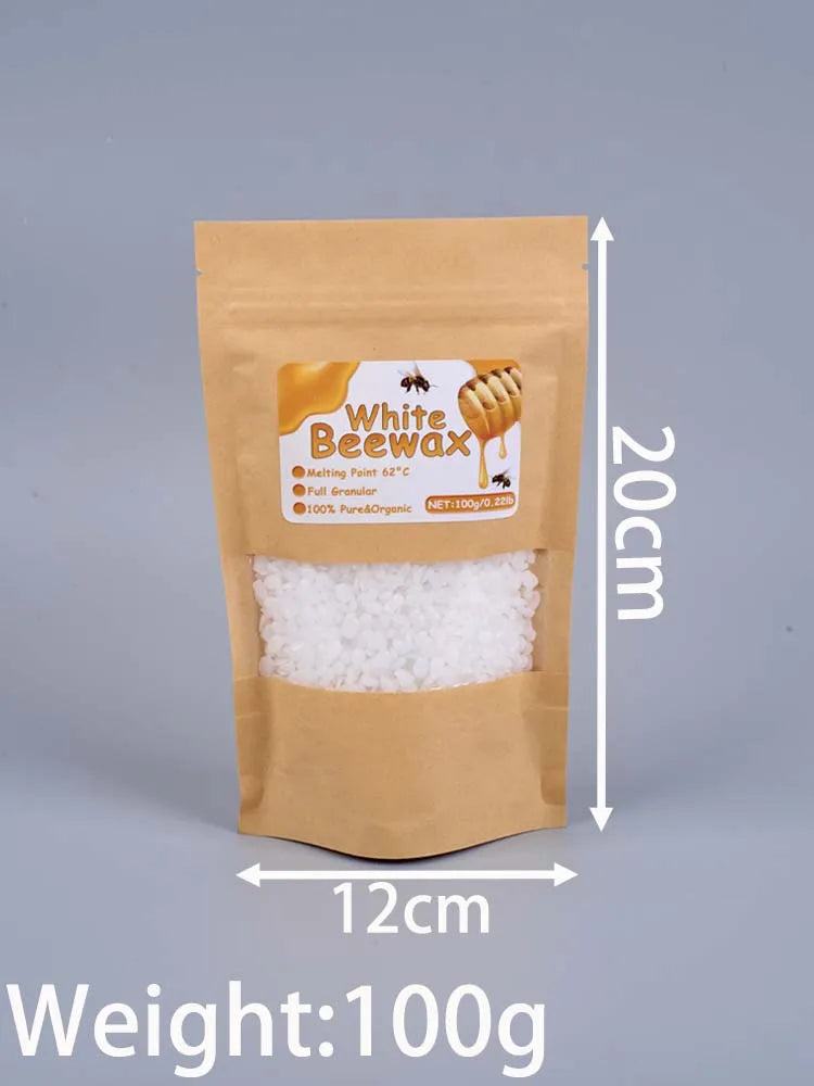 A brown paper bag containing 100g of white beeswax pellets for DIY candle making.