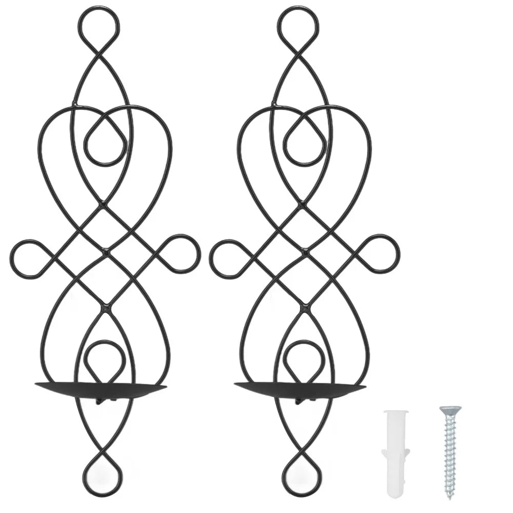 A set of two decorative black iron wall candle sconces with an ornate, swirling design.