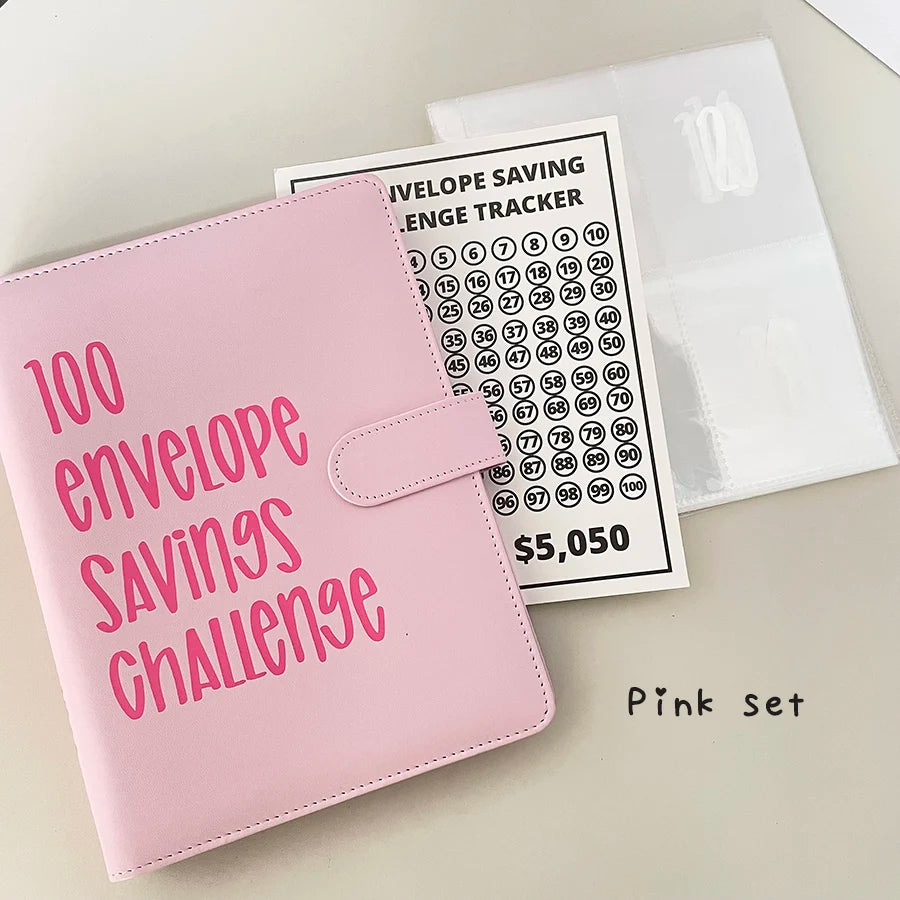 A pink A5 binder for a 100 envelope savings challenge with numbered pockets and a corresponding tracker sheet.