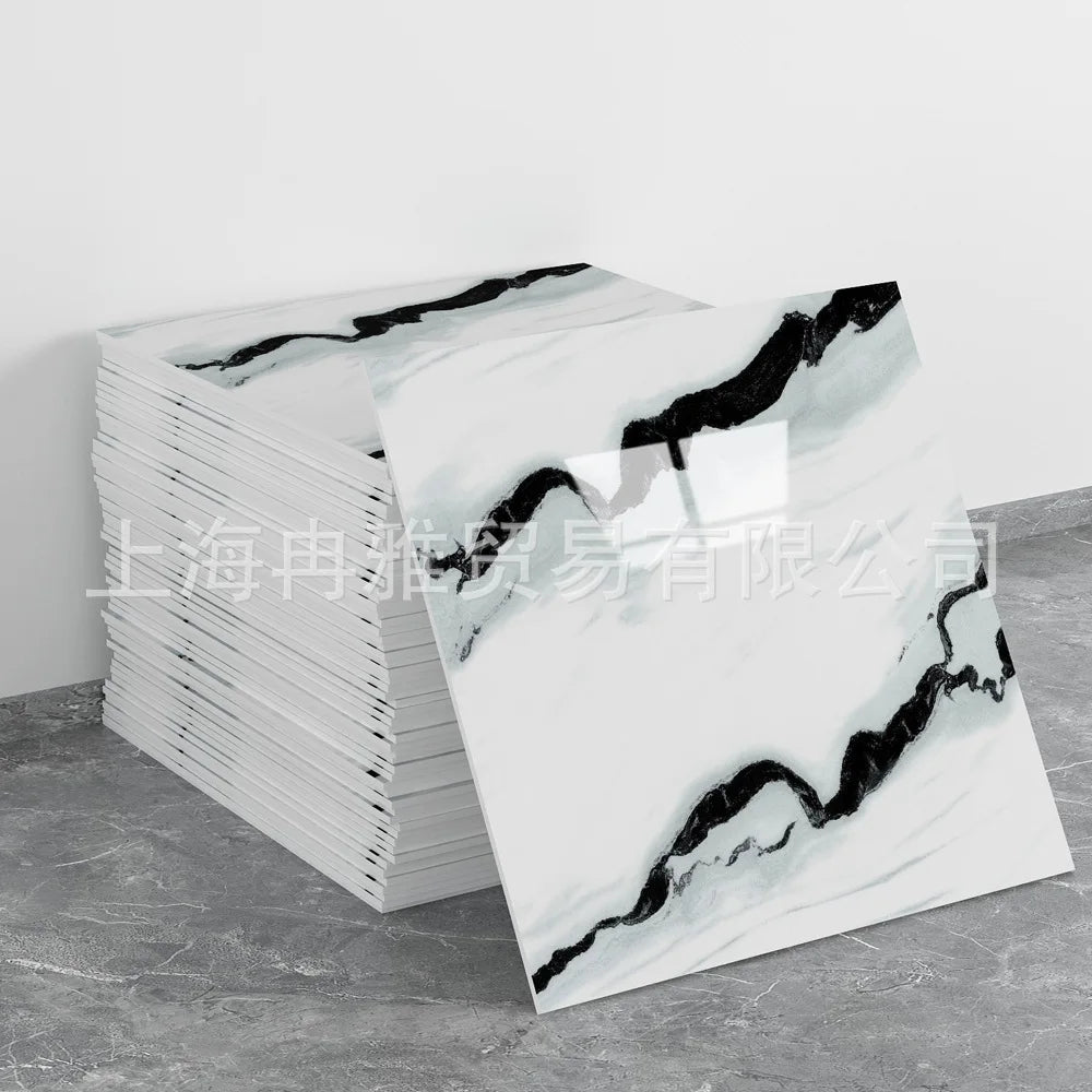 A stack of faux marble self-adhesive wall tiles featuring black veining on a gray background.