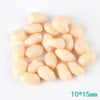 A small pile of pale yellow resin fake corn miniatures for crafting and décor