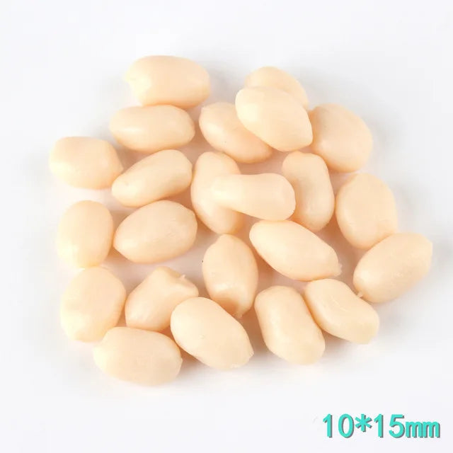 A small pile of pale yellow resin fake corn miniatures for crafting and décor