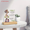 A clear acrylic print featuring a Christian message about God's grace and forgiveness, displayed on a wooden base.