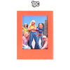 An orange magnetic photo frame holding a picture of five young women.
