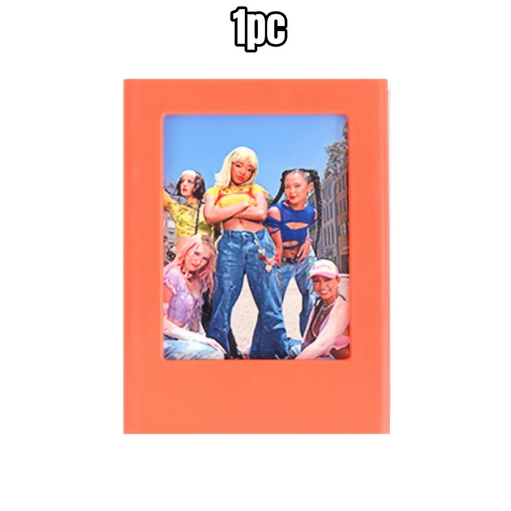 An orange magnetic photo frame holding a picture of five young women.