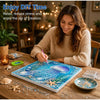 A woman is painting an ocean scene with diamonds on a canvas, surrounded by sea shells and glitter.