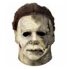 A close-up of a Halloween Michael Myers latex mask with a bloody scar detail on the face.