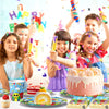 A colorful birthday party setup featuring cake, cupcakes, and various toys with children celebrating.
