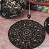 A black wooden pendulum board with zodiac signs and words like Yes No Maybe on it.
