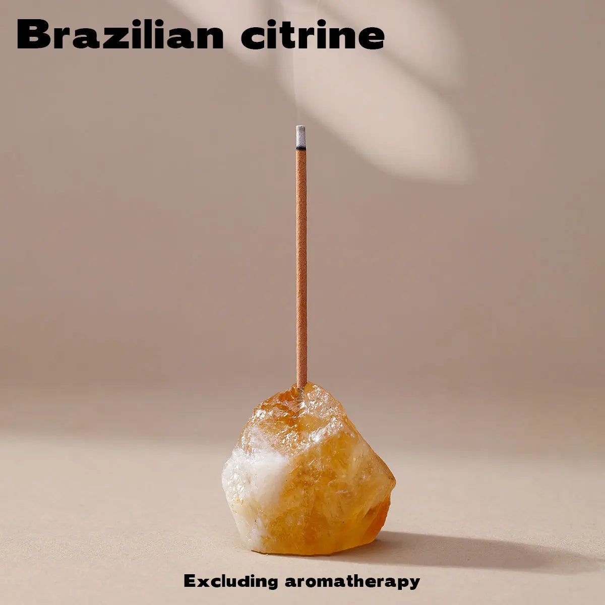 A natural citrine crystal is mounted on a wooden stick for use as an aromatherapy holder.