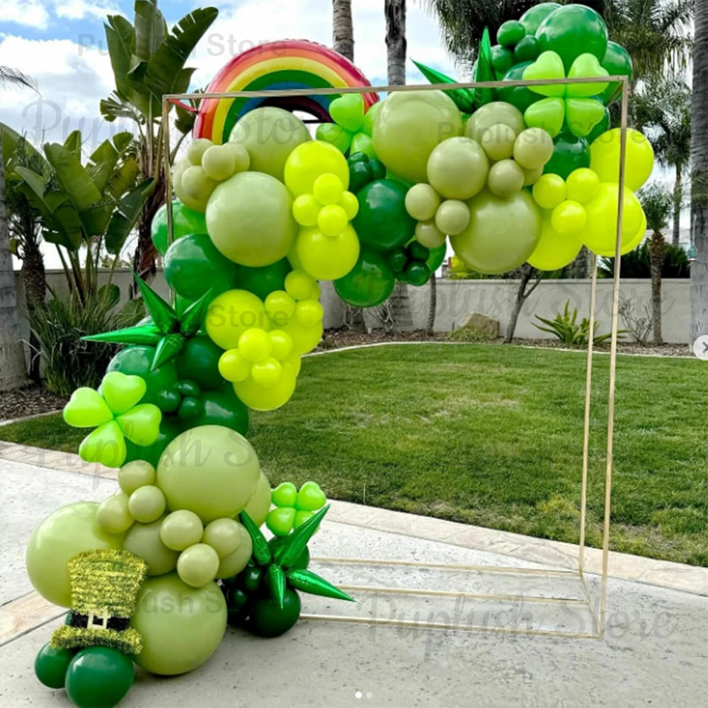 A vibrant archway made of sage green latex balloons in various shades, including lime green and yellow, set up outdoors.