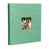 A green linen front scrapbook memory book with a photo of a family.