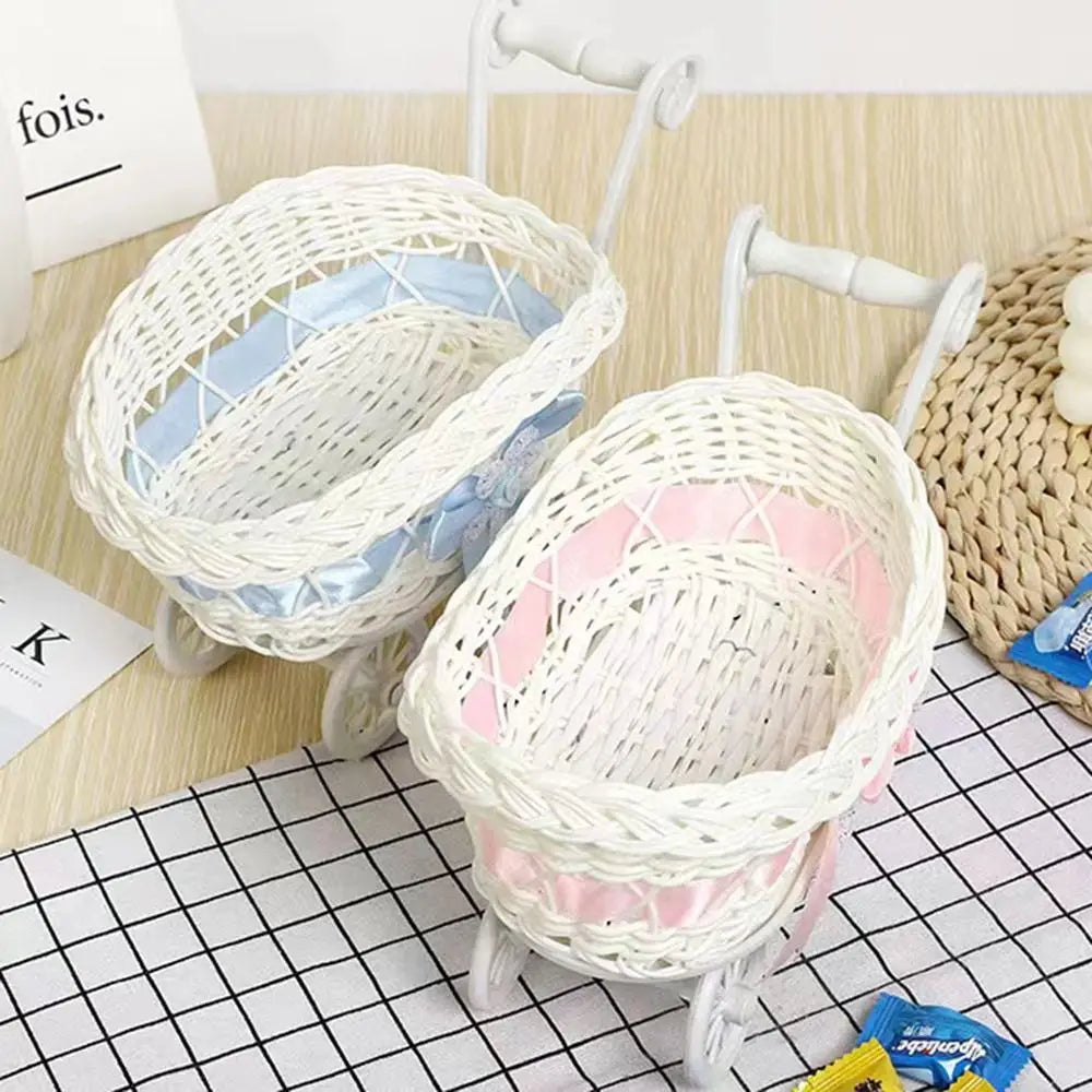 White and light blue faux rattan woven storage basket with handles on a black grid surface.