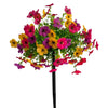 A bouquet of colorful artificial petunias in shades of pink, purple, and yellow on a black stake.
