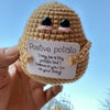Handmade crochet potato doll with a positivity card featuring the text I may be a tiny potato but I believe in you go do your