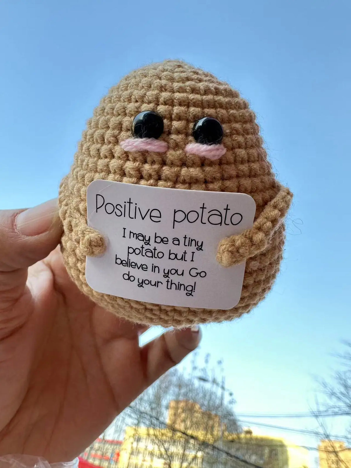 Handmade crochet potato doll with a positivity card featuring the text I may be a tiny potato but I believe in you go do your