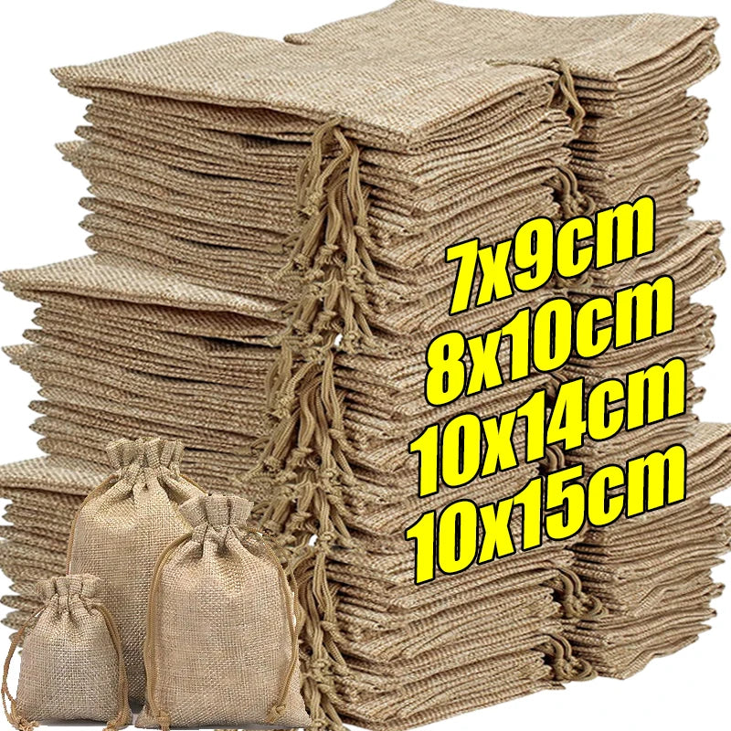 A stack of natural burlap drawstring bags in beige and tan colors.