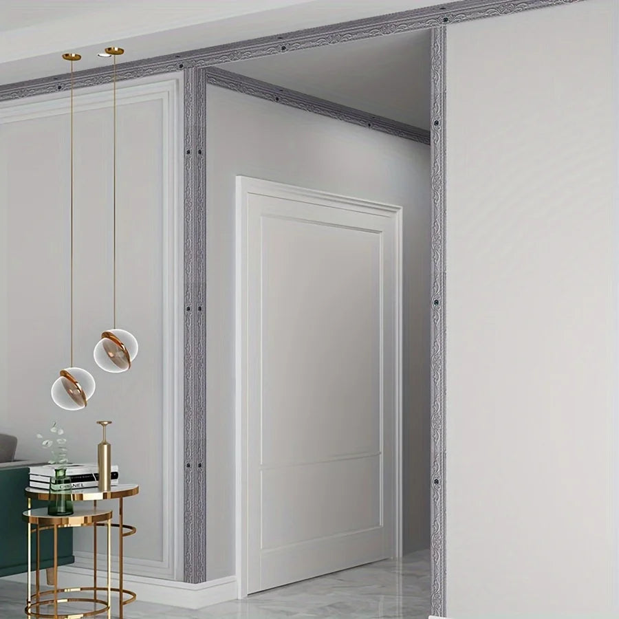 A close-up of white wall trim strips with a gray textured finish installed on a white wall.