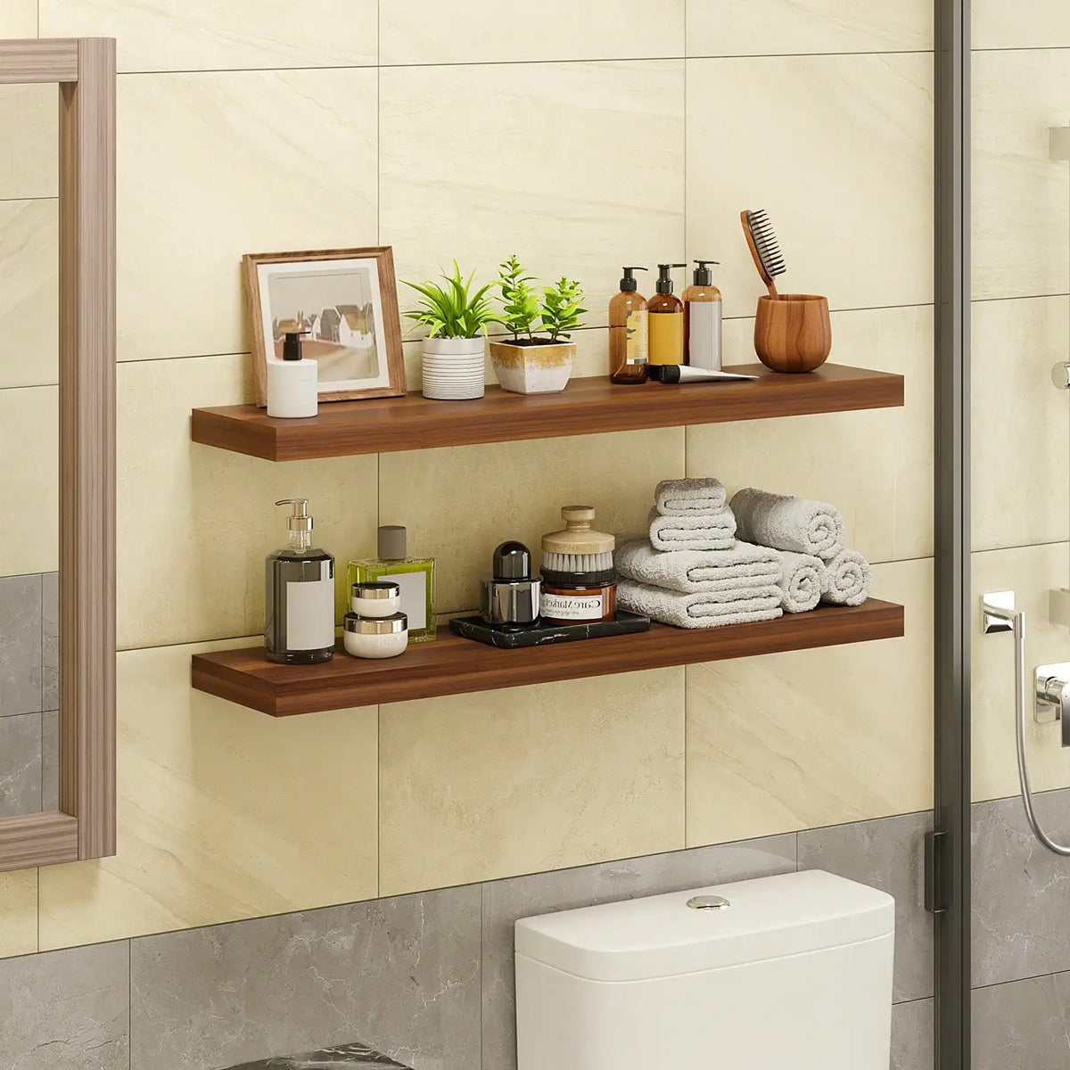 Two wooden floating wall shelves displaying skincare products and toiletries above a toilet.