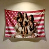 A tapestry featuring five women in light-colored outfits against a red, white, and blue striped background with stars.