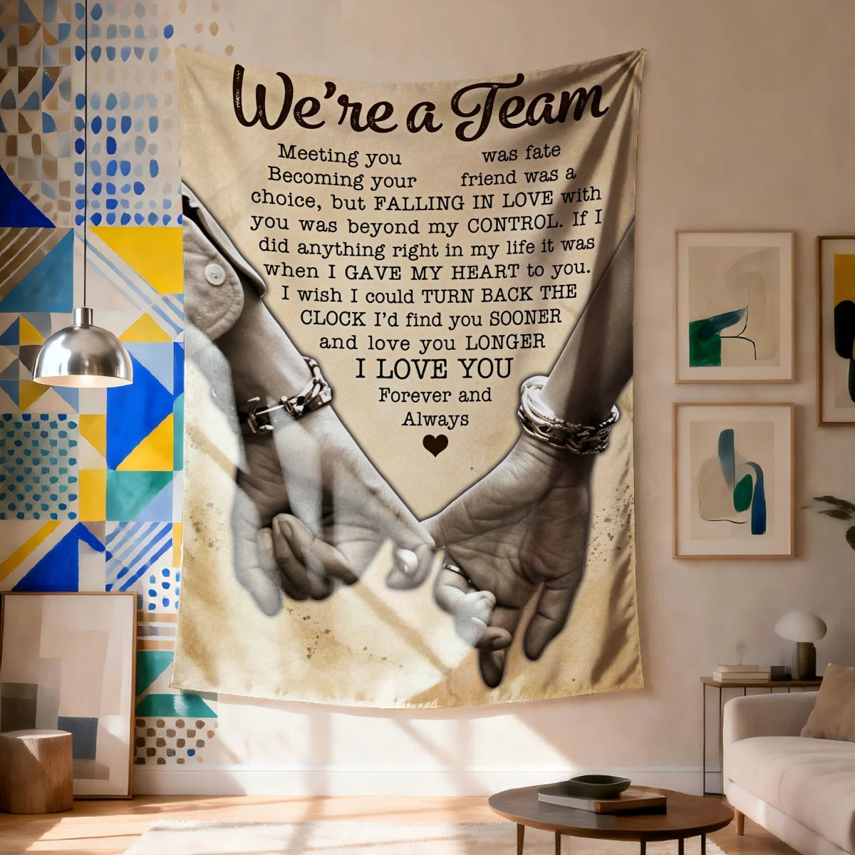 A fabric wall tapestry featuring a hand-holding design with text that reads We're a Team and I love you